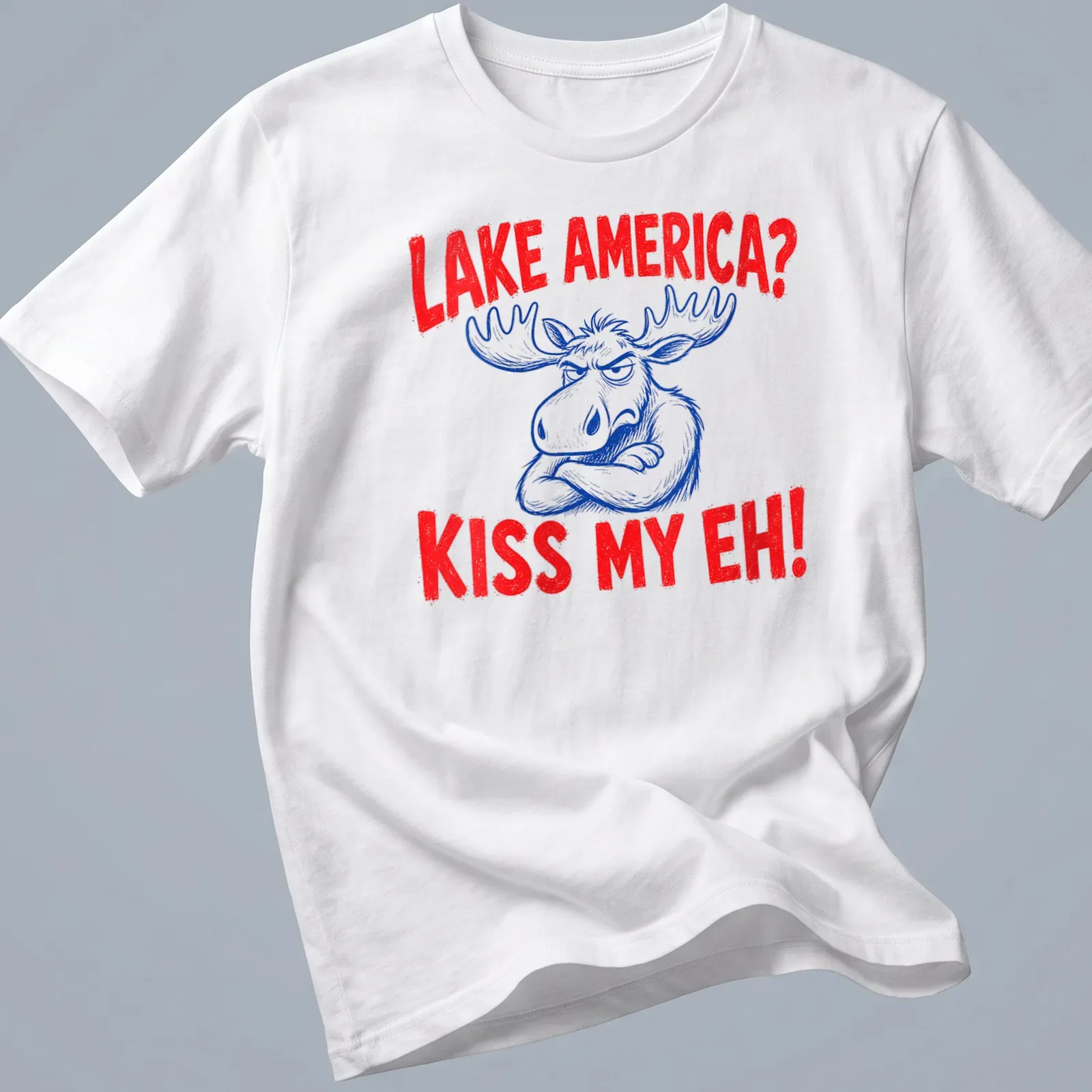 Cartoon moose graphic with the text 'Lake America? Kiss My Eh!' in red, blue, and white — printed on a unisex t-shirt