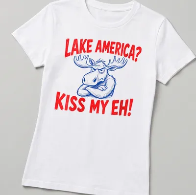 Cartoon moose graphic with the text 'Lake America? Kiss My Eh!' in red, blue, and white — printed on a women's shirt