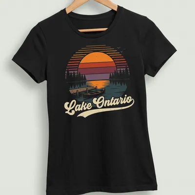 Retro vintage print of Lake Ontario with a canoe and dock at sunset. — printed on a women's shirt