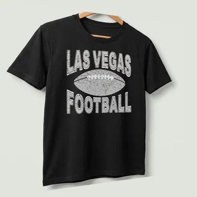Retro distressed Las Vegas Football t-shirt with bold text and a football graphic — printed on a unisex t-shirt (angled view)