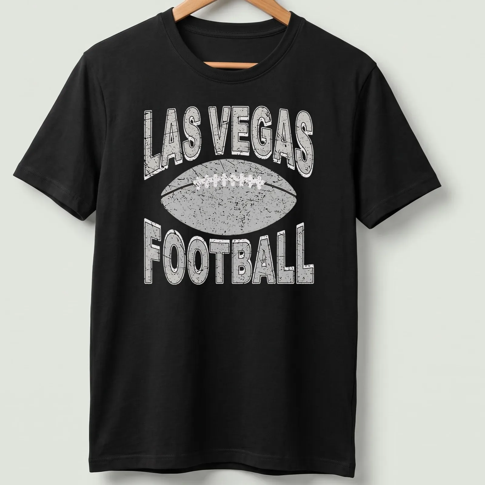 Retro distressed Las Vegas Football t-shirt with bold text and a football graphic — printed on a unisex t-shirt