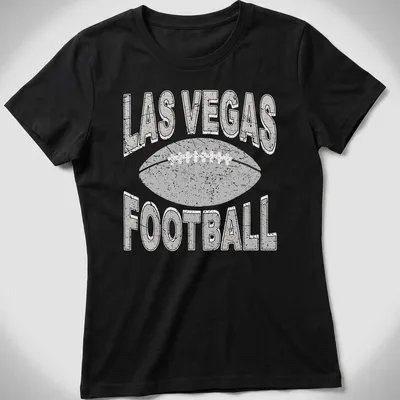Retro distressed Las Vegas Football t-shirt with bold text and a football graphic — printed on a women's shirt