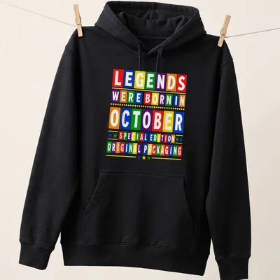 Colorful birthday-themed t-shirt with block letters celebrating October birthdays — printed on a unisex hoodie