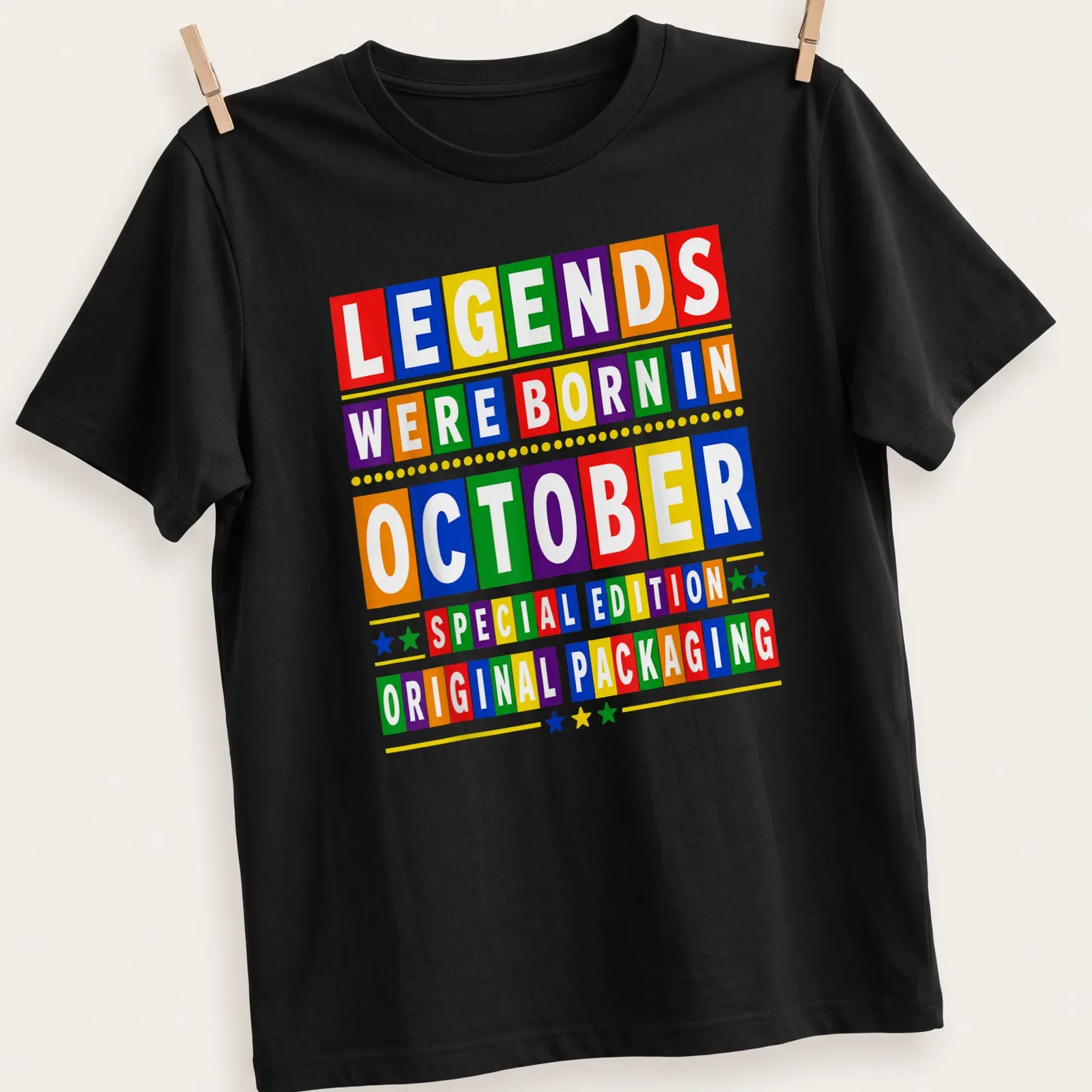 Colorful birthday-themed t-shirt with block letters celebrating October birthdays — printed on a unisex t-shirt