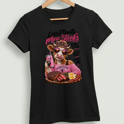 Colorful cartoon cow eating steak with humorous text about energy and happiness. — printed on a women's shirt