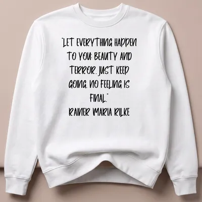 Inspirational quote by Rainer Maria Rilke in handwritten script on a white — printed on a unisex sweatshirt