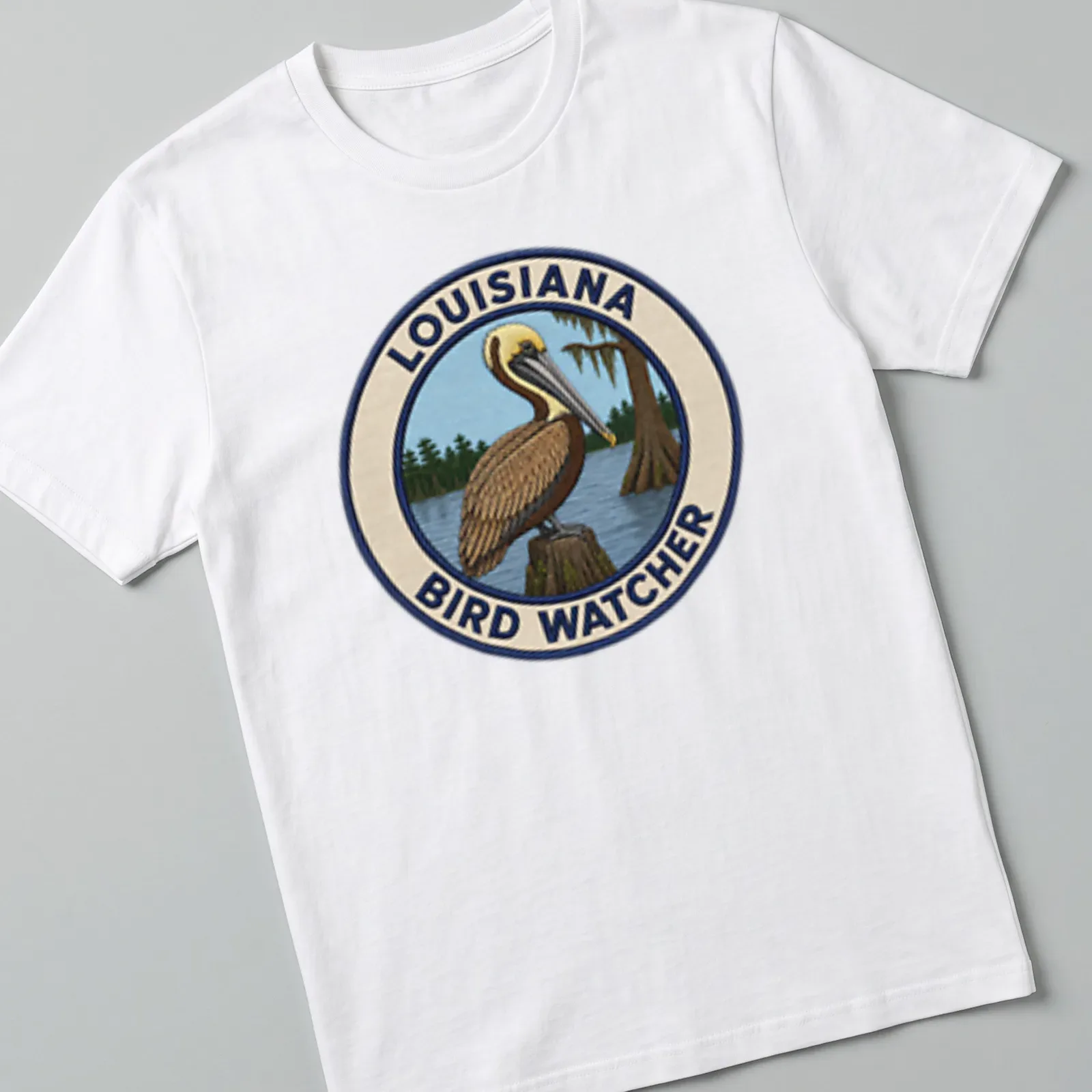 Detailed patch design of a Brown Pelican with Louisiana Bird Watcher text — printed on a unisex t-shirt