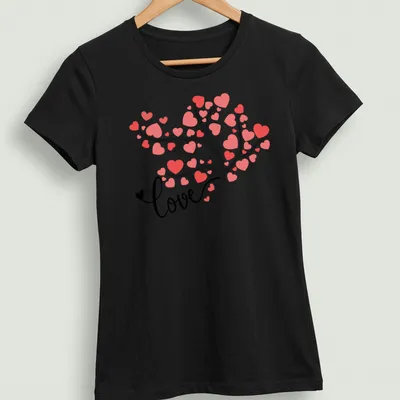 Modern illustrated T-shirt with a tree and colorful hearts spelling love — printed on a women's shirt