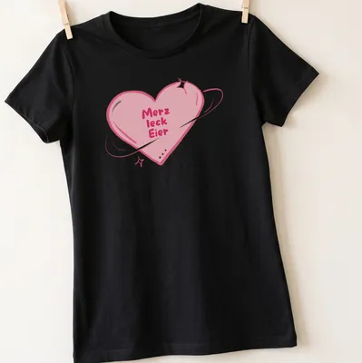Kawaii style shirt with a heart and playful text 'Merz leck Eier' in pink and purple — printed on a women's shirt
