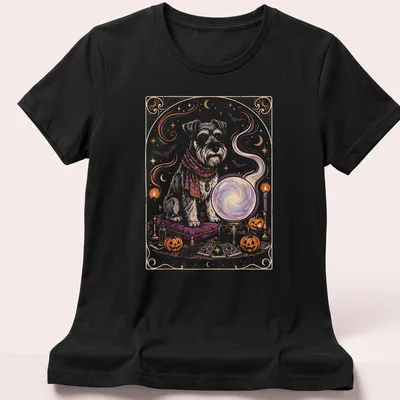 Whimsical illustration of a Mini Schnauzer with a crystal ball in Halloween colors — printed on a women's shirt