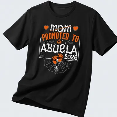 Halloween-themed t-shirt with text celebrating a mom becoming an abuela and baby feet