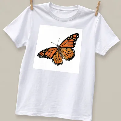 Geometric orange and black Monarch butterfly illustration on a T-shirt