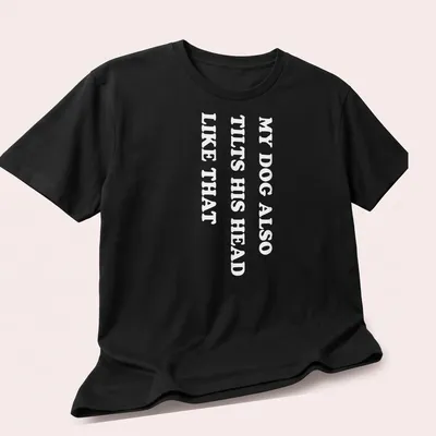 Funny t-shirt with the text 'MY DOG ALSO TILTS HIS HEAD LIKE THAT' — printed on a unisex t-shirt (angled view)