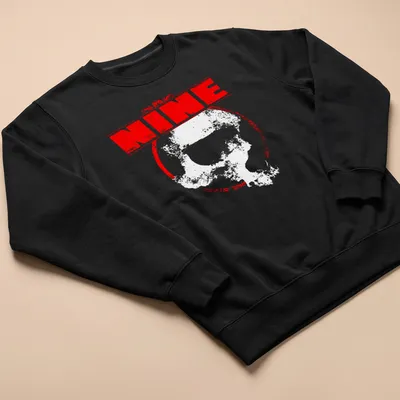 Distressed T-shirt featuring the word 'NINE' above a design of skulls in red and white. — printed on a unisex sweatshirt