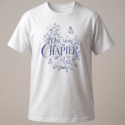 Elegant botanical design featuring an open book with flowers and butterflies, and 'One More Chapter' text — printed on a unisex t-shirt
