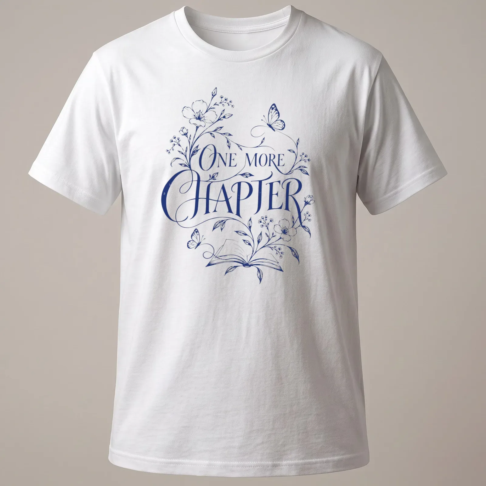 Elegant botanical design featuring an open book with flowers and butterflies, and 'One More Chapter' text — printed on a unisex t-shirt