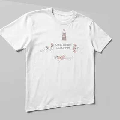 Line-art graphic tee showing the text 'One More Chapter...' with book-themed illustrations — printed on a unisex t-shirt (angled view)