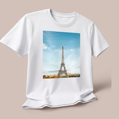 Photographic print of Eiffel Tower with text 'Paris, France' in blue and gold — printed on a unisex t-shirt (angled view)
