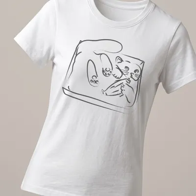 Simple line-art of a playful kitten wiggling in a tray in black and white — printed on a women's shirt