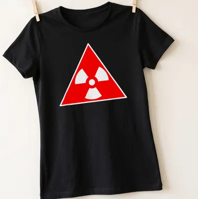 Vintage radioactive symbol graphic on a red — printed on a women's shirt