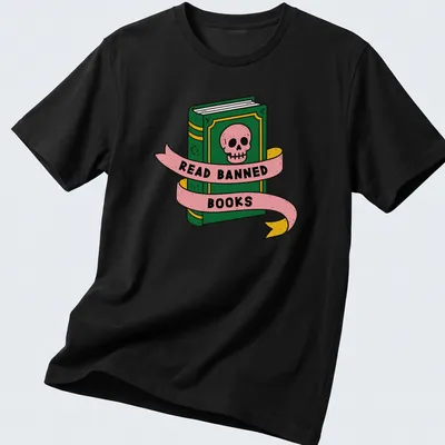 Bold cartoon design featuring a skull and book with the text 'READ BANNED BOOKS' — printed on a unisex t-shirt