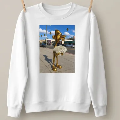 Realistic print of a golden statue holding cash, set against vibrant colors — printed on a unisex sweatshirt