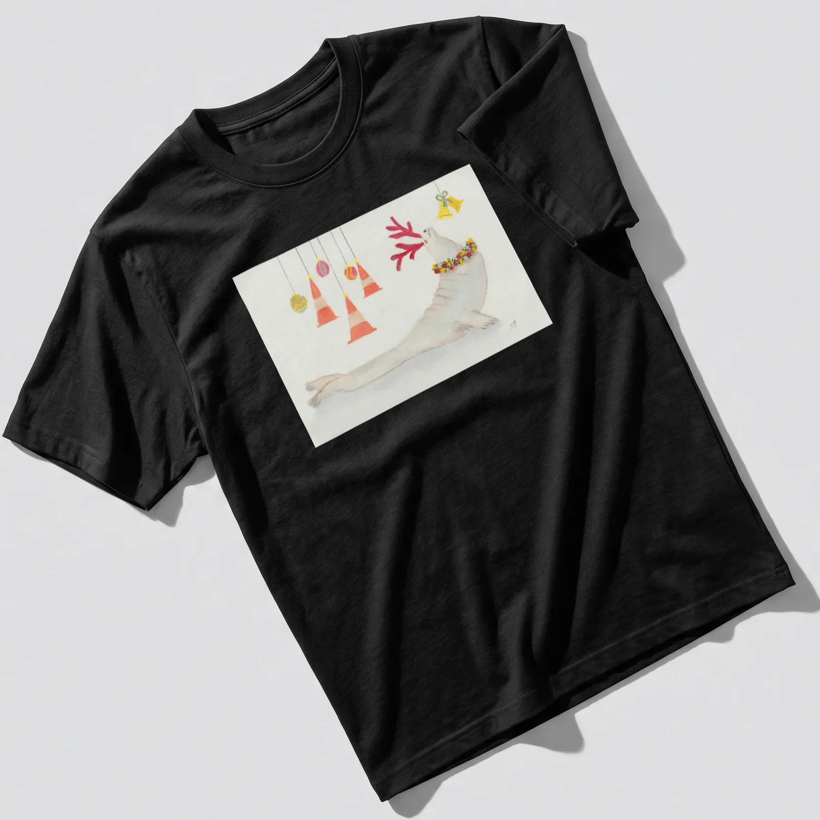 Watercolor print of a seal with antlers and festive decorations in various colors — printed on a unisex t-shirt