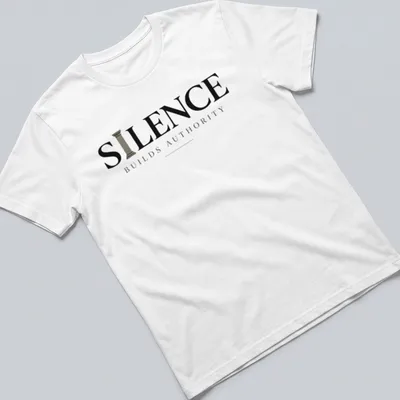 Minimal typography quote t-shirt with the phrase 'Silence Builds Authority' in black and gray text — printed on a unisex t-shirt