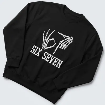 White t-shirt with skeleton hands and the text SIX SEVEN in a fun design. — printed on a unisex sweatshirt