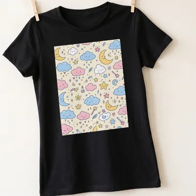Kawaii pattern of clouds, stars, and moons in pink, blue, yellow, and cream. — printed on a women's shirt