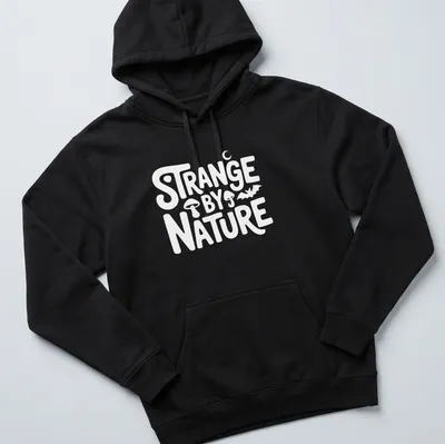 Colorful nature scene t-shirt featuring the text 'Strange By Nature' above an illustration. — printed on a unisex hoodie