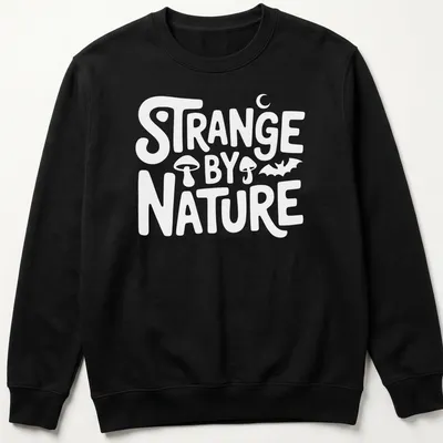 Colorful nature scene t-shirt featuring the text 'Strange By Nature' above an illustration. — printed on a unisex sweatshirt