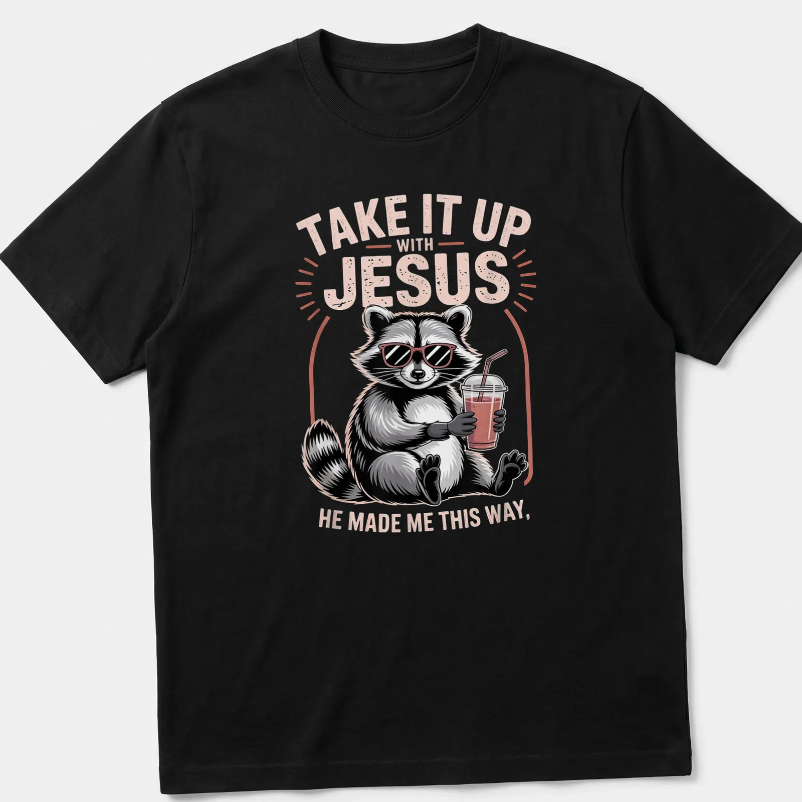Cartoon raccoon holding a drink with humorous text about Jesus — printed on a unisex t-shirt