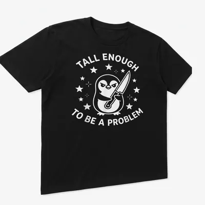 Funny cartoon penguin t-shirt with text about being tall enough to be a problem — printed on a unisex t-shirt (angled view)