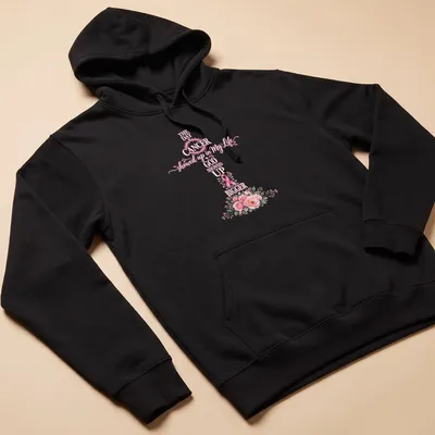 Floral shirt with a cross, pink ribbon, and script that reads about faith in the face of cancer — printed on a unisex hoodie