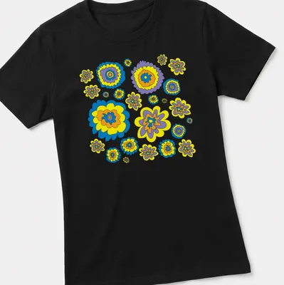 Graphic t-shirt featuring colorful flowers in blue, yellow, purple, and orange — printed on a women's shirt