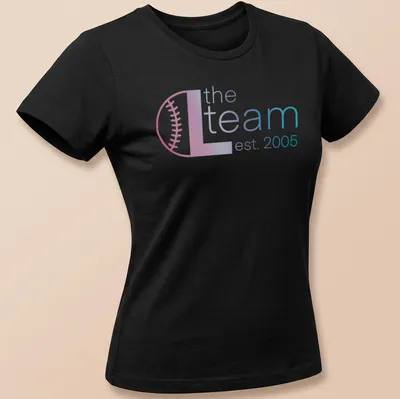 Modern gradient design with text 'the L team est. 2005' in pink, blue, and white — printed on a women's shirt