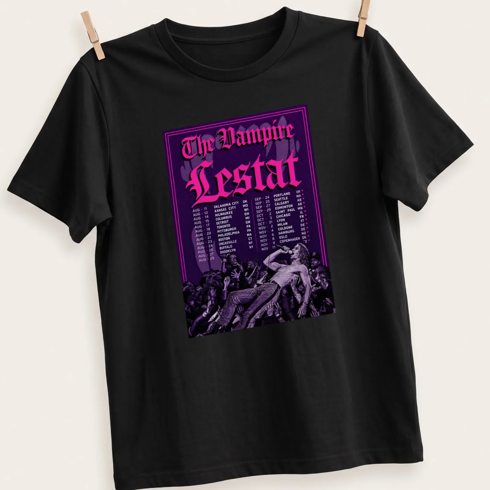 Gothic-style Vampire Lestat concert schedule t-shirt in purple, black, and pink — printed on a unisex t-shirt