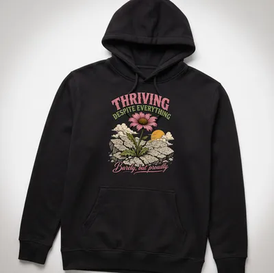 Illustrative T-shirt featuring a flower growing through cracks with a motivating message — printed on a unisex hoodie