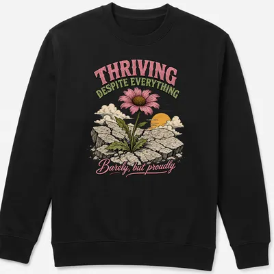 Illustrative T-shirt featuring a flower growing through cracks with a motivating message — printed on a unisex sweatshirt