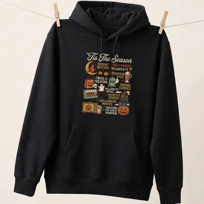 Retro Halloween-themed t-shirt with pumpkin and festive icons — printed on a unisex hoodie