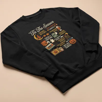 Retro Halloween-themed t-shirt with pumpkin and festive icons — printed on a unisex sweatshirt