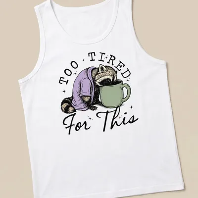 Vintage illustration of a raccoon face down in a coffee cup with playful text — printed on a tank top