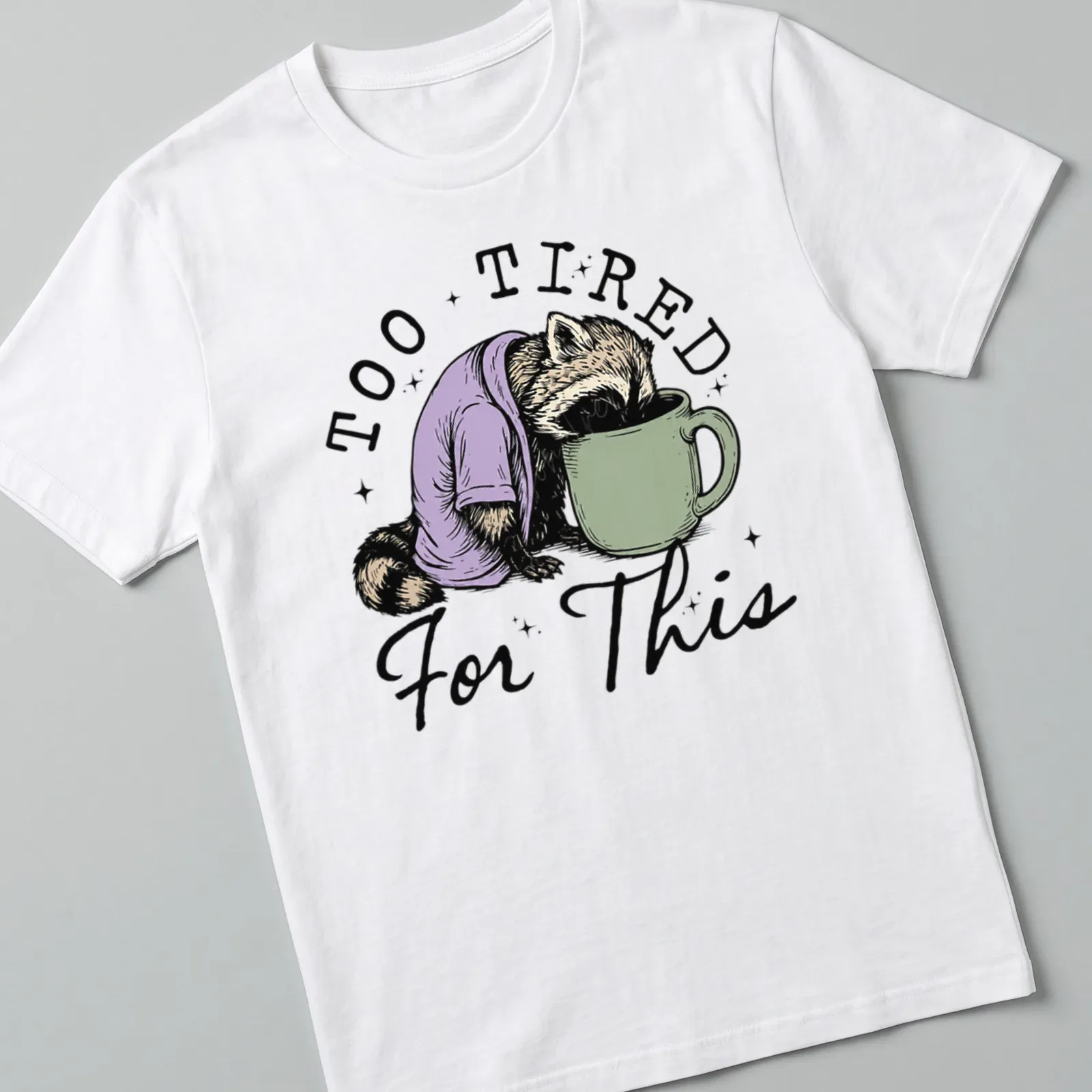 Vintage illustration of a raccoon face down in a coffee cup with playful text — printed on a unisex t-shirt