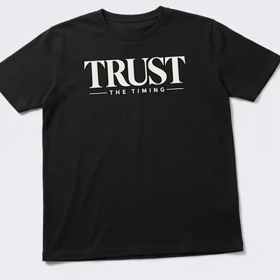Bold typography shirt featuring the motivational quote 'Trust The Timing' in black and white