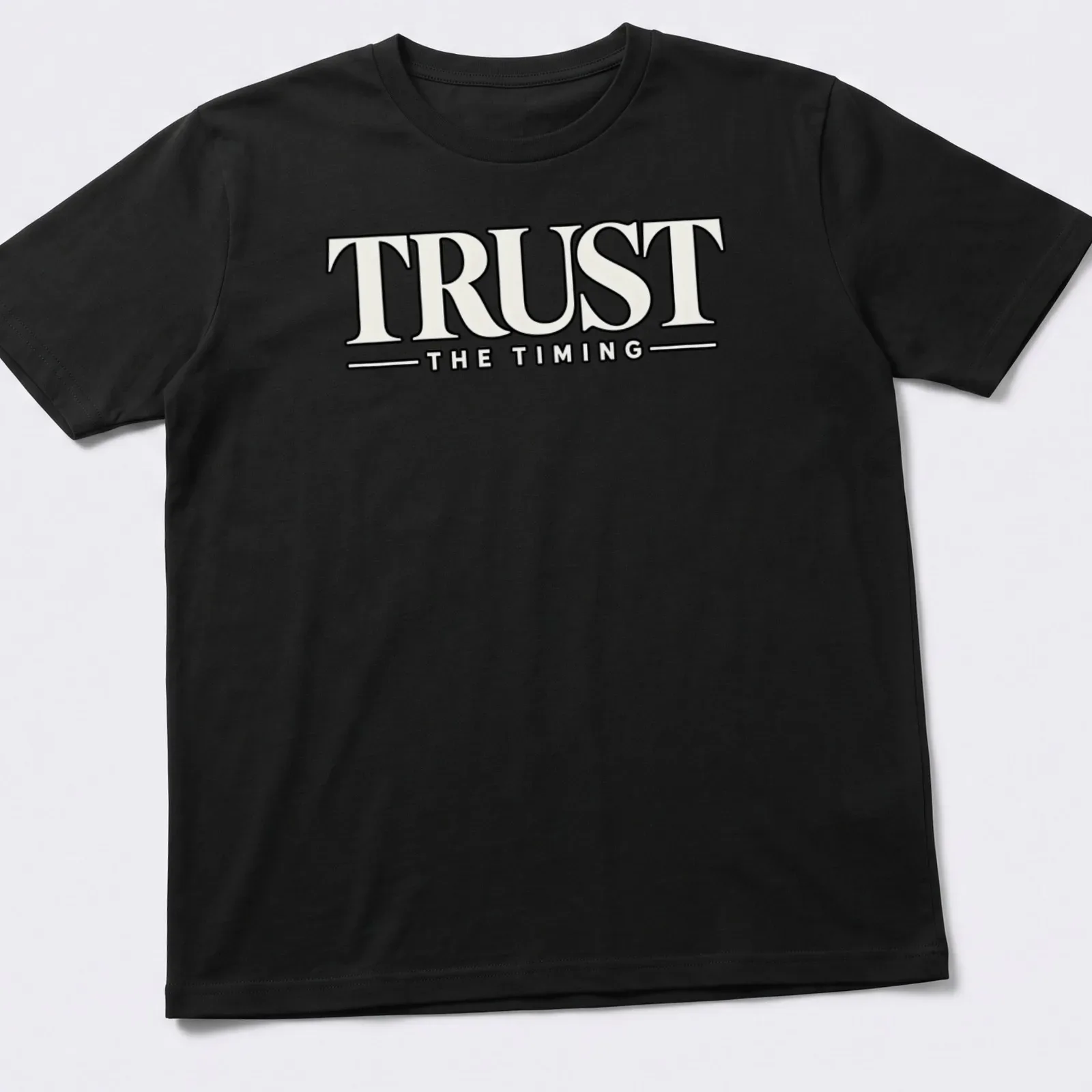 Bold typography shirt featuring the motivational quote 'Trust The Timing' in black and white — printed on a unisex t-shirt