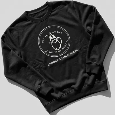 Circular badge design featuring the text Vet Tech By Day Witch By Night with a cat. — printed on a unisex sweatshirt