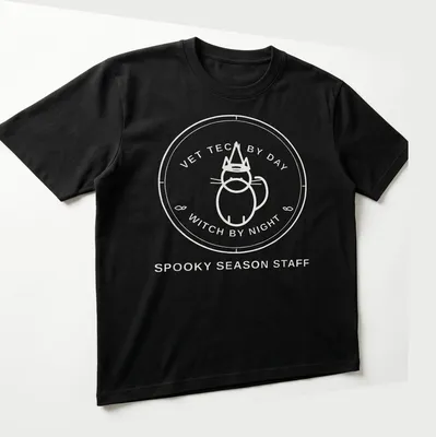 Circular badge design featuring the text Vet Tech By Day Witch By Night with a cat. — printed on a unisex t-shirt (angled view)