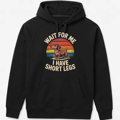 Retro Dachshund t-shirt with humorous text about short legs in warm colors — printed on a unisex hoodie