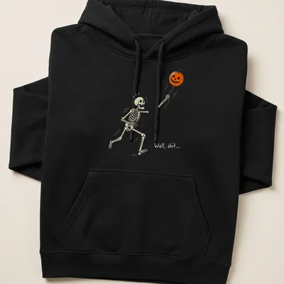Cartoon skeleton chasing a pumpkin balloon with humorous text above — printed on a unisex hoodie